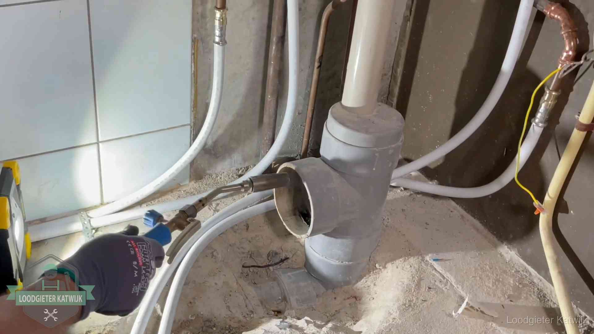 Loodgieter werkt aan leidingen bij de pvc-standleiding van een huurwoning in Katwijk